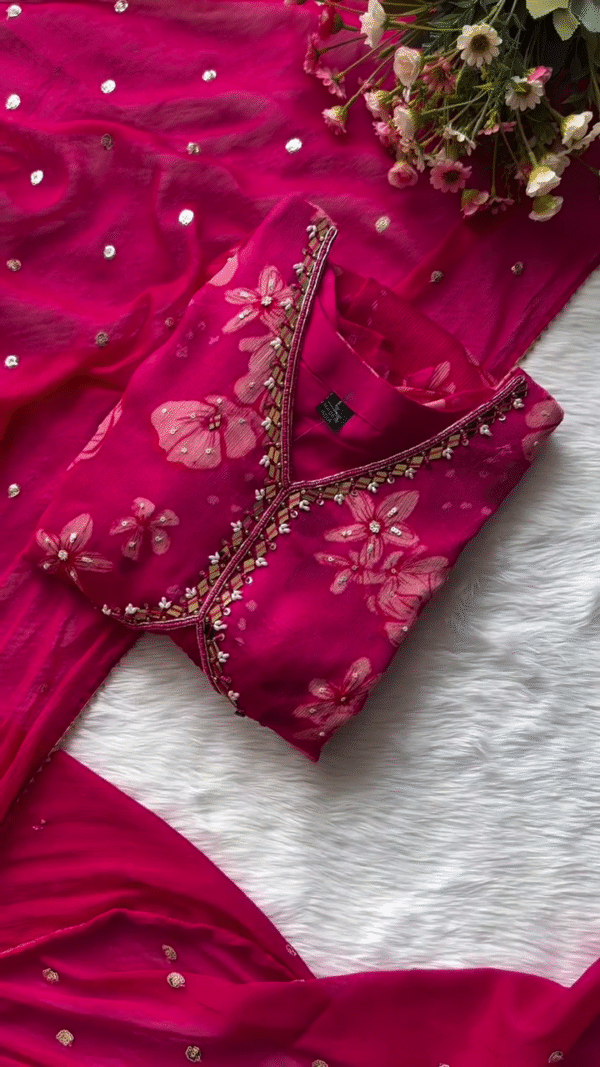 Deep Pink Floral Printed Georgette Suit Set with Hand-Embellished Mirror Work Neckline, Soft Matching Dupatta with Sequin Detailing, and Coordinated Elasticated Bottoms – Perfect for Festive and Special Occasions