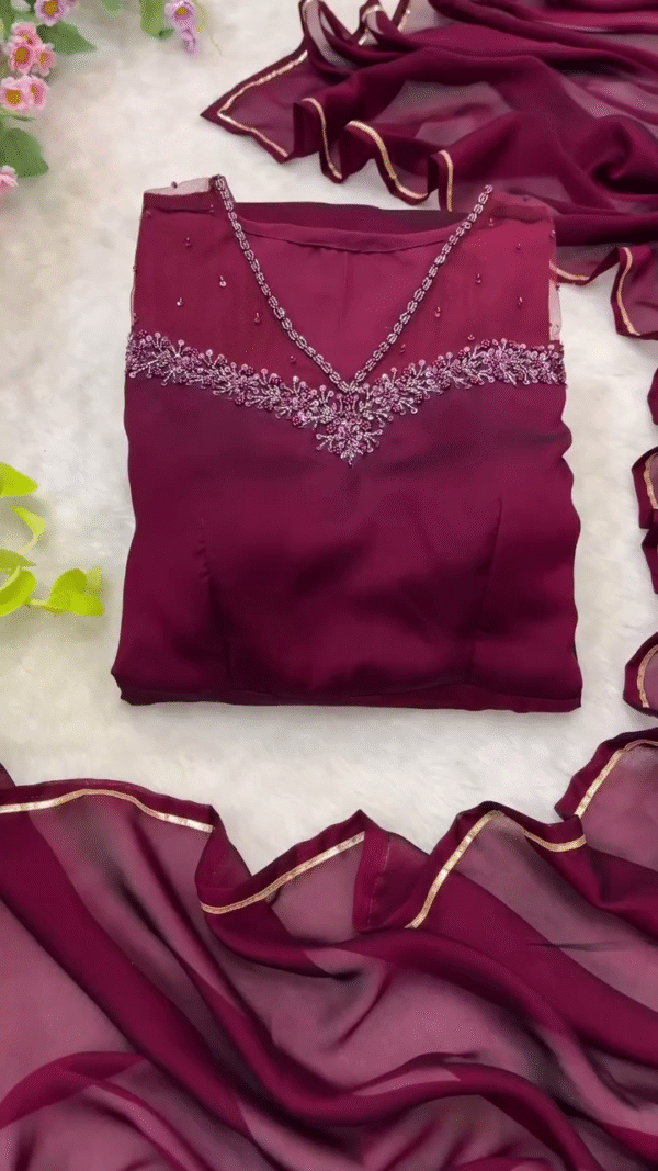 Graceful Wine Maroon Georgette Anarkali Gown with Intricate Embroidery on V-Neckline, Full Sleeves, and Flowy Flared Silhouette – Ideal for Festive, Party, and Traditional Occasions
