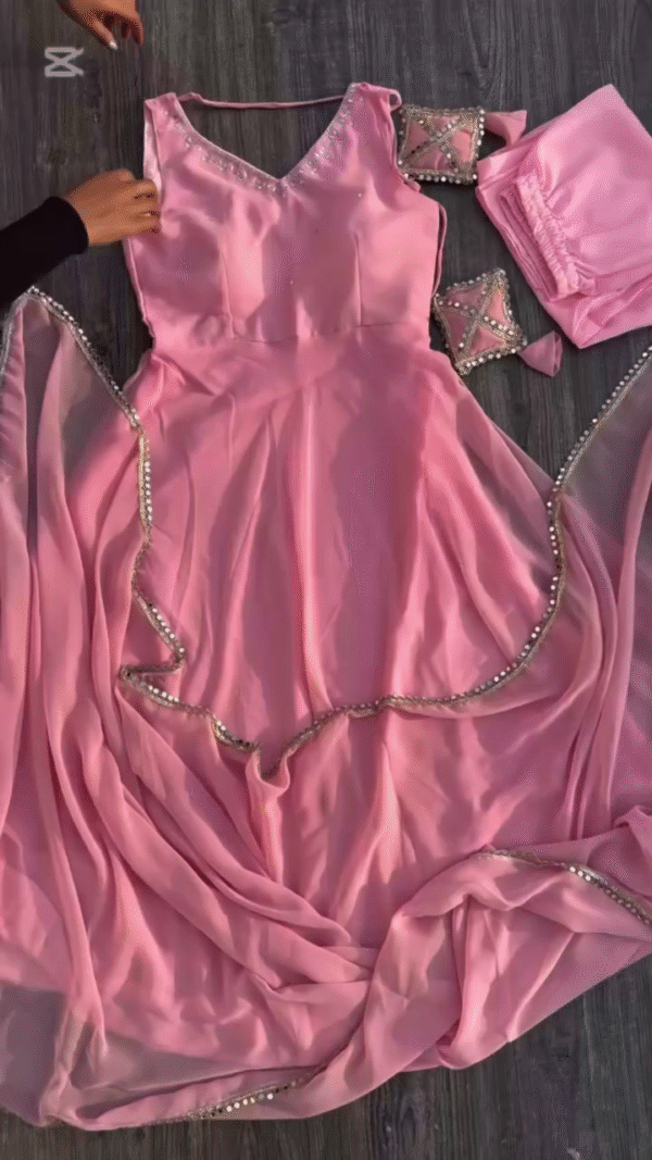 A gorgeous pink dress with delicate beaded detailing along the edges, accompanied by a matching dupatta and pants.