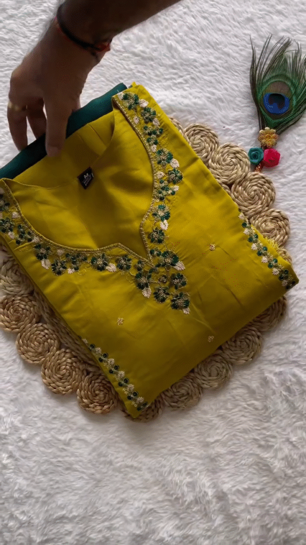 Vibrant Mustard Straight-Cut Kurta Set with Delicate Mirror Work and Floral Embroidery – Paired with a Contrasting Deep Green Dupatta Featuring Intricate Scalloped Lace Border – A Bold Yet Elegant Pick for Festive and Casual Occasions.