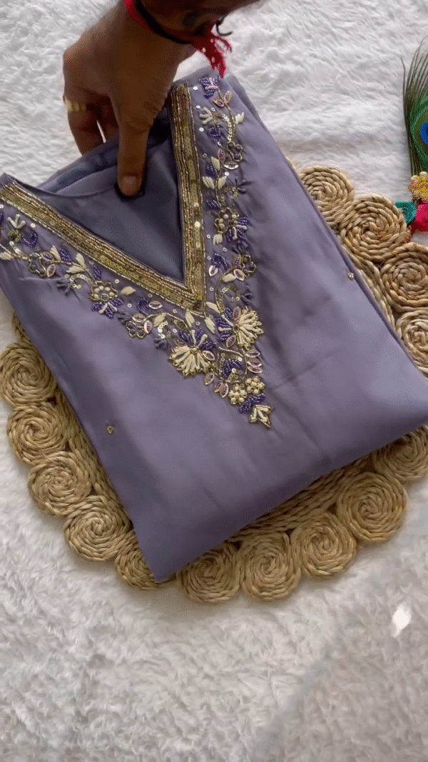 Dusty Lavender Straight-Cut Kurta Set with Delicate Golden & Purple Thread Embroidery on the Neckline – Paired with a Sheer Printed Dupatta Featuring Abstract Leaf Motifs – A Sophisticated and Subtle Ensemble for Elegant Daywear and Light Festive Moments.