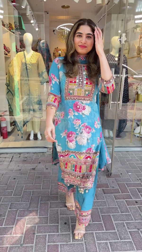 Charming Sky Blue Straight-Cut Suit with Bold Floral Prints and Multicolor Embroidered Neck Panel – Enhanced with Ethnic Motifs, Mirror Work Highlights, and Matching Printed Trousers – A Perfect Pick for Festive Daywear and Cultural Gatherings - Image 2