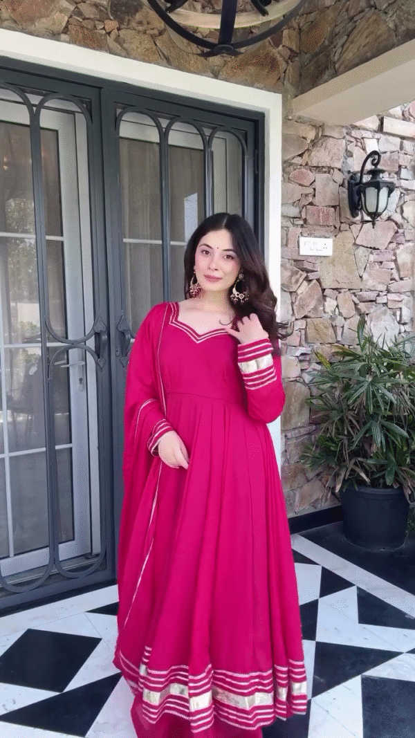 Vibrant Fuchsia Pink Anarkali Dress with Golden Border Detailing, Paired with a Coordinating Dupatta for a Traditional Festive Look - Image 2