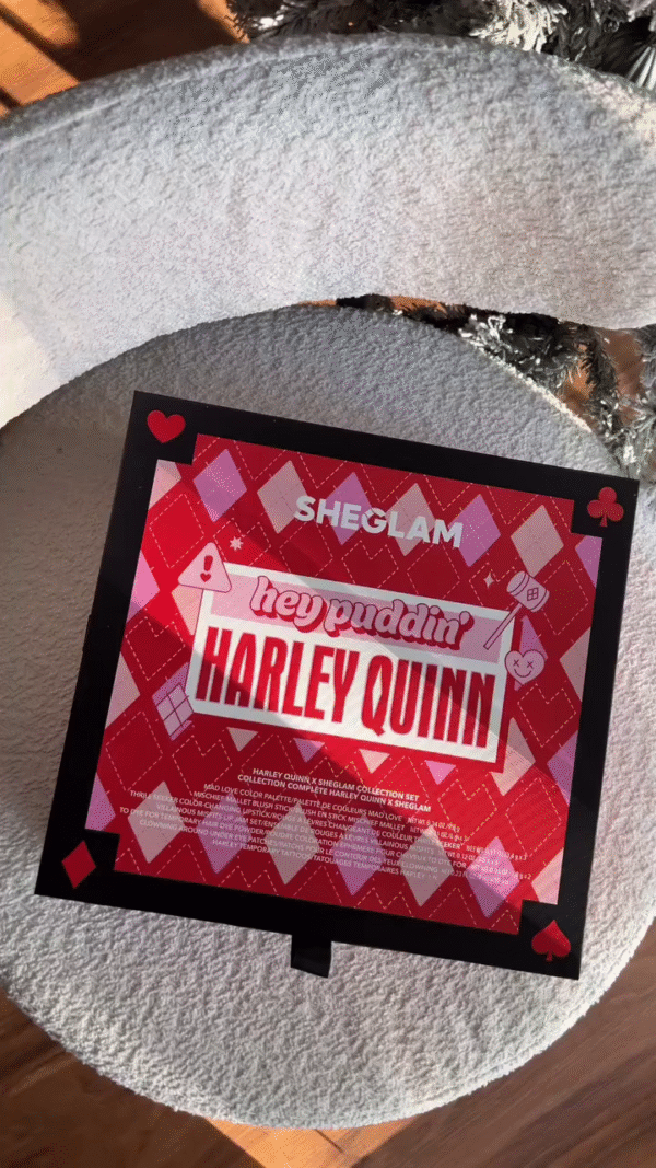 A Harley Quinn-themed makeup collection featuring vibrant, bold colors in various textures. The set includes lip tints in jars with creative designs