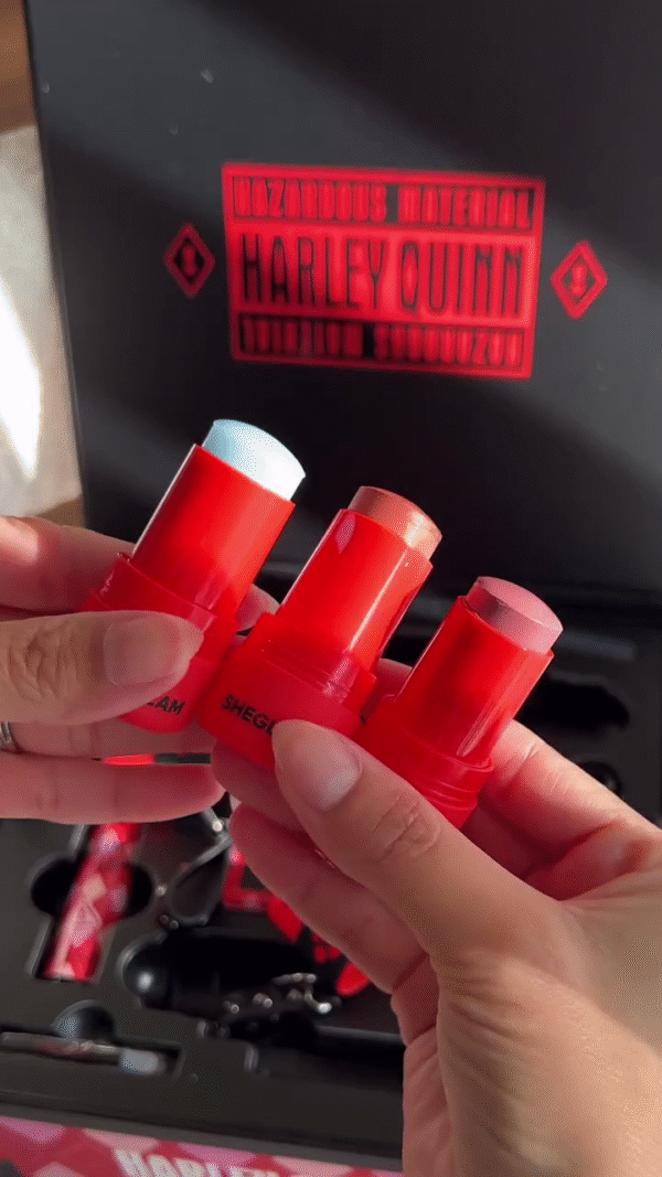 A Harley Quinn-themed makeup collection featuring vibrant, bold colors in various textures. The set includes lip tints in jars with creative designs - Image 2