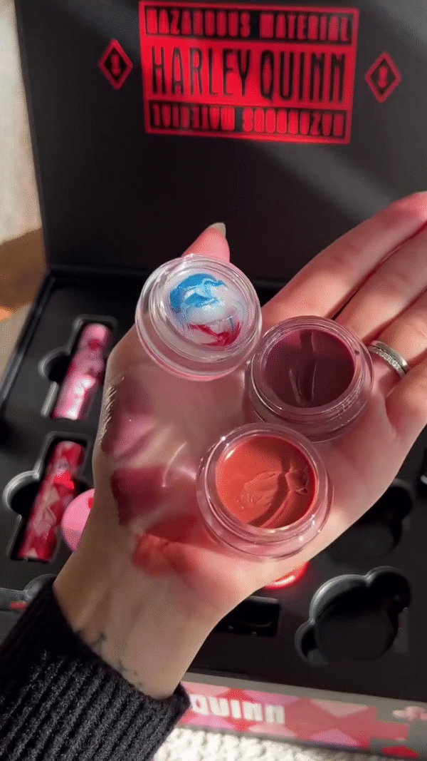 A Harley Quinn-themed makeup collection featuring vibrant, bold colors in various textures. The set includes lip tints in jars with creative designs - Image 3