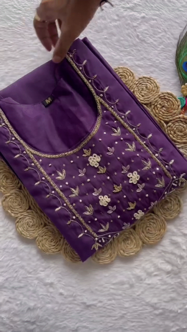 Elegant Purple Suit Set adorned with delicate floral embroidery around the neckline, paired with a soft net dupatta featuring subtle printed blossoms and a golden border — a perfect choice for festive occasions or graceful evening wear.