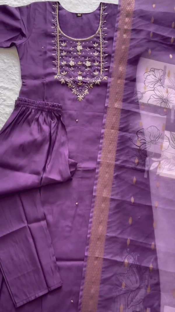 Elegant Purple Suit Set adorned with delicate floral embroidery around the neckline, paired with a soft net dupatta featuring subtle printed blossoms and a golden border — a perfect choice for festive occasions or graceful evening wear. - Image 2