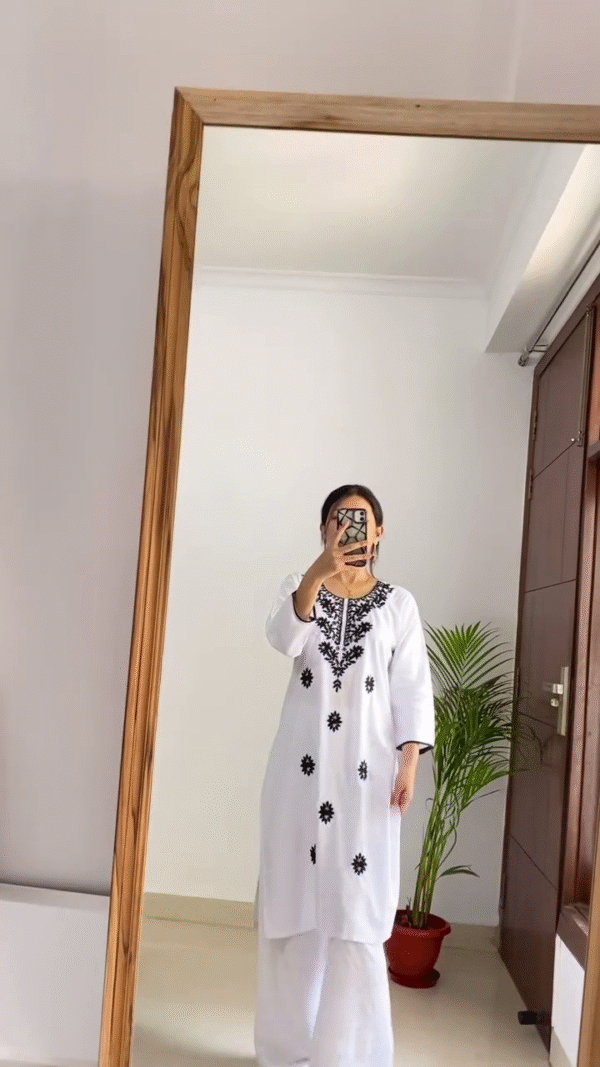 Women’s White Embroidered Kurti Tops — Featuring Black Floral Neckline Design with Matching White Wide-Leg Pants for a Graceful Ethnic Look, and Pink Geometric