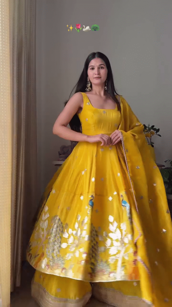 Yellow Anarkali Gown with Dupatta – Sleeveless Traditional Outfit Featuring Intricate Silver Embroidery and Beautiful Peacock Motifs for Weddings, Festivals, and Special Occasions