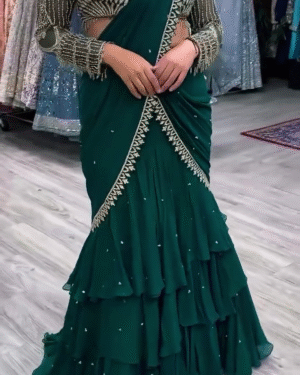 Royal Emerald Green Tiered Ruffle Saree Gown with Heavily Embellished Full-Sleeve Illusion Blouse – Designer Pre-Draped Fusion Saree Featuring Crystal Hand-Work, Scalloped Embroidery, and Voluminous Tiered Skirt for Red Carpet, Cocktail, and Luxury Wedding Wear