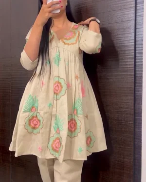 Whimsical Off-White Short Peplum Kurta Set with Pastel Floral Appliqué and Contemporary Straight-Fit Trousers