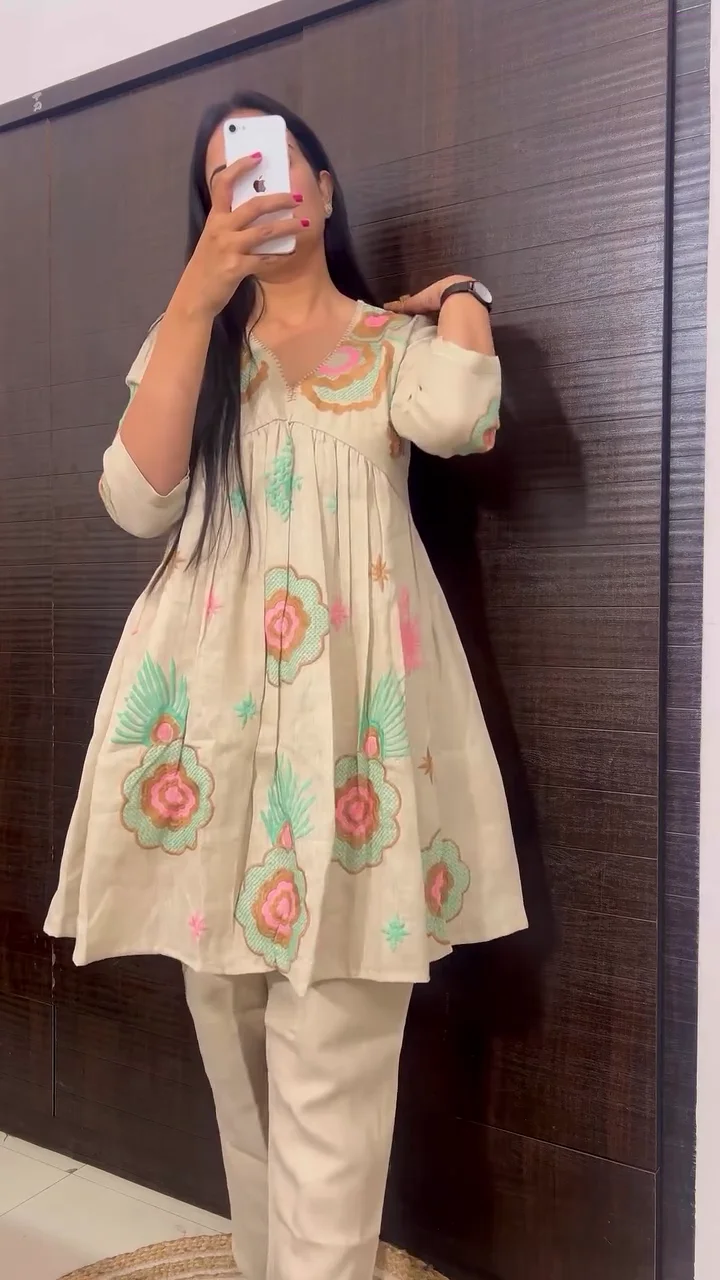 Whimsical Off-White Short Peplum Kurta Set with Pastel Floral Appliqué and Contemporary Straight-Fit Trousers